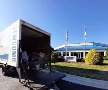 Newcomb Truck parked outside of their office location